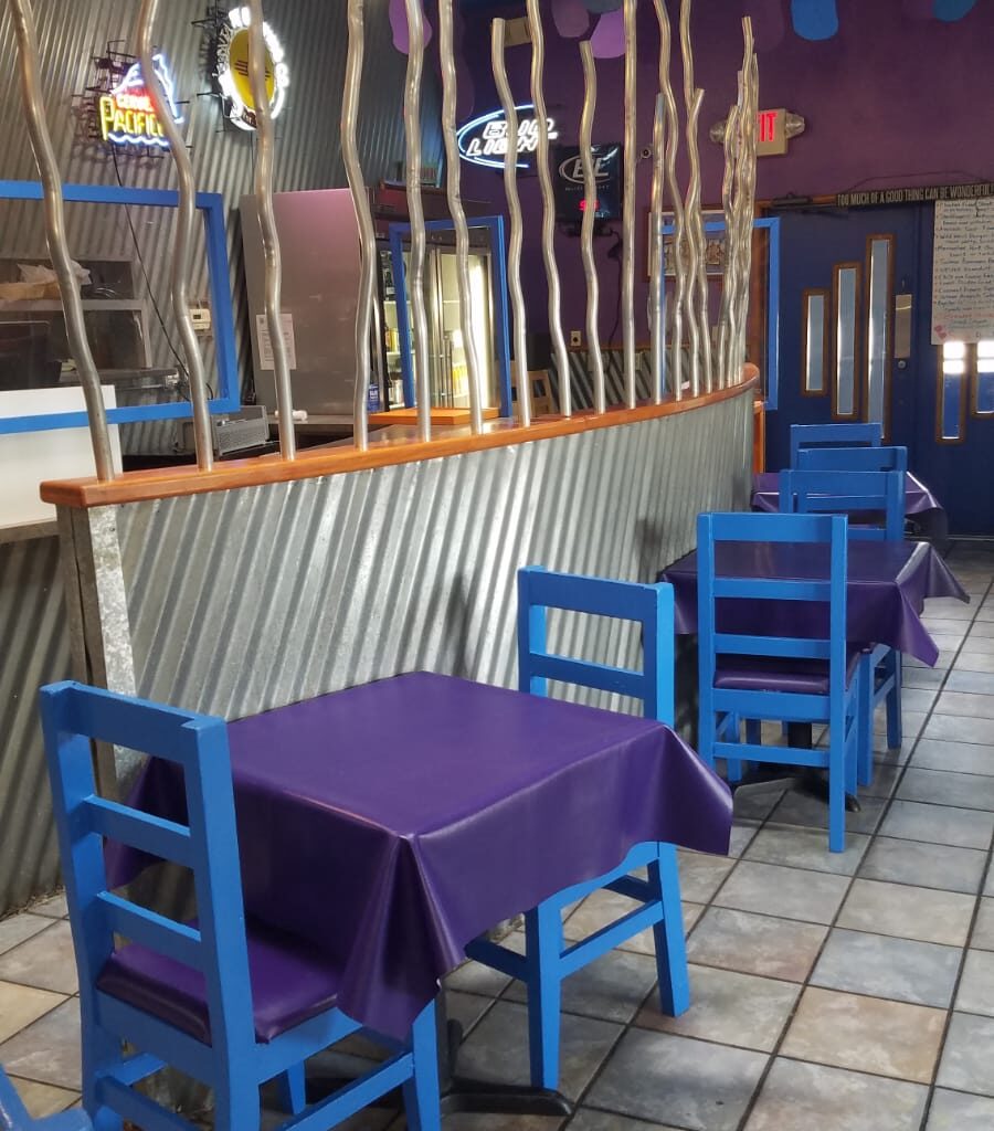 A restaurant with tables and chairs in the middle of it