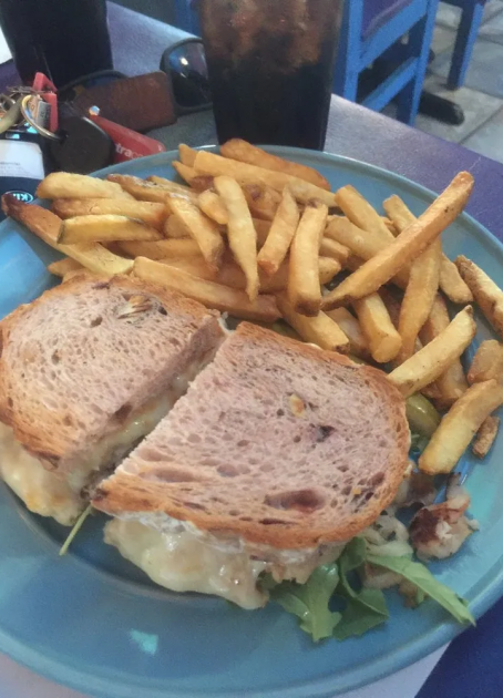 A sandwich and fries on a plate.